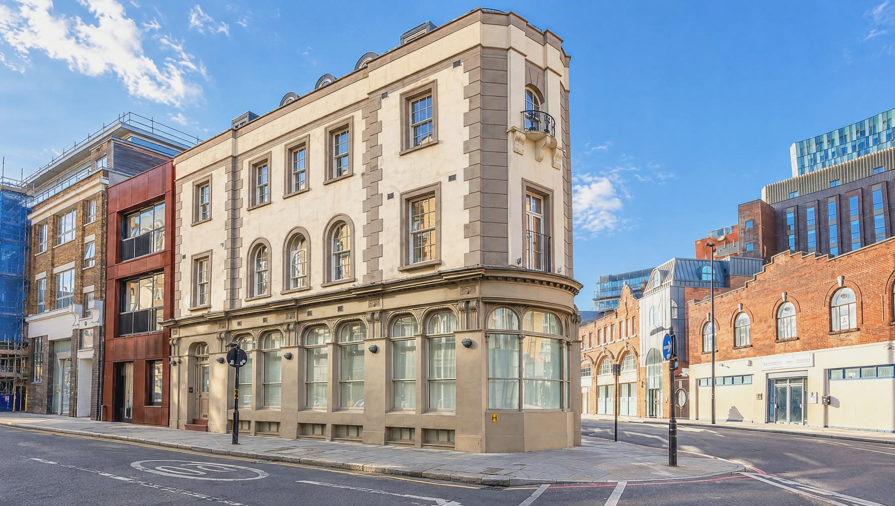 The cream stucco corner of Britannia Street and King's Cross Road, with round-arched ground-floor windows